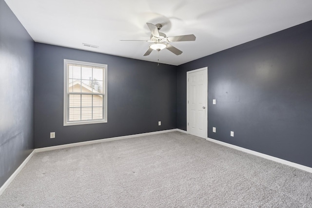 spare room featuring visible vents, baseboards, carpet, and a ceiling fan