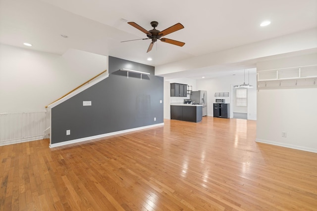 unfurnished living room with light wood finished floors, recessed lighting, baseboards, and a ceiling fan