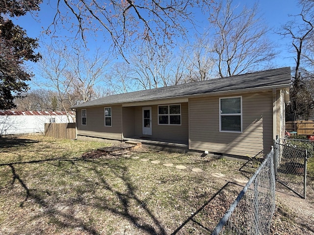 rear view of house featuring crawl space and fence