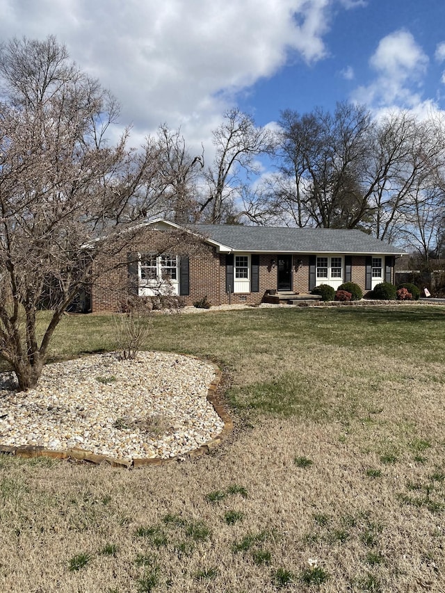 ranch-style house with brick siding and a front lawn