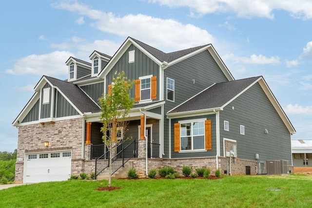 craftsman inspired home featuring board and batten siding, a front lawn, a porch, stone siding, and an attached garage