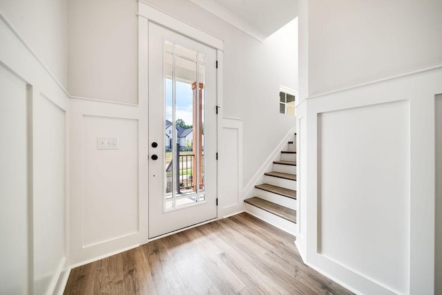 foyer with wood finished floors and stairs