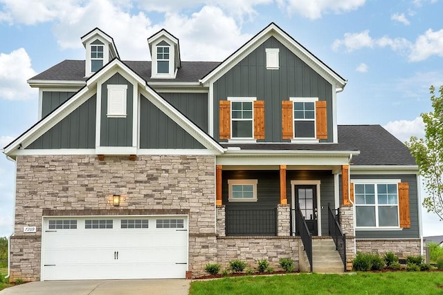 craftsman-style house featuring driveway, a porch, stone siding, a garage, and board and batten siding