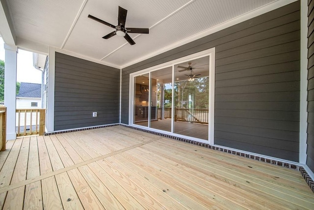 wooden terrace with a ceiling fan