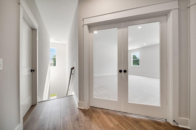 doorway with recessed lighting, french doors, baseboards, and wood finished floors