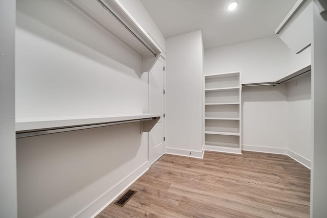 walk in closet featuring visible vents and wood finished floors