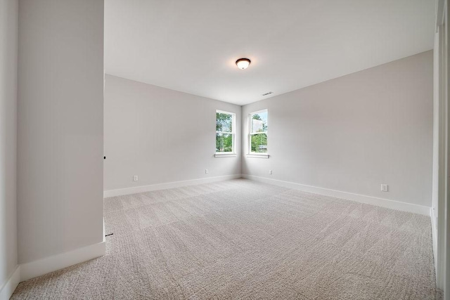 carpeted empty room with baseboards