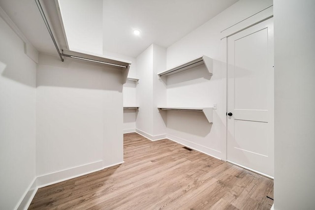 spacious closet featuring visible vents and wood finished floors