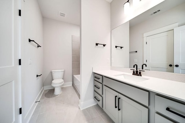 full bath featuring vanity, toilet, baseboards, and visible vents