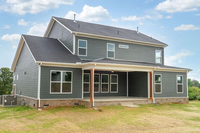 rear view of house with crawl space, a yard, roof with shingles, and central AC