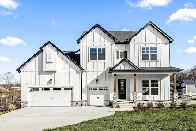 modern farmhouse with driveway, stone siding, board and batten siding, an attached garage, and a shingled roof