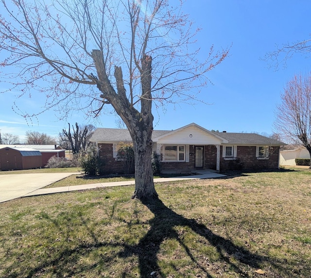 view of front of home with a front yard and brick siding