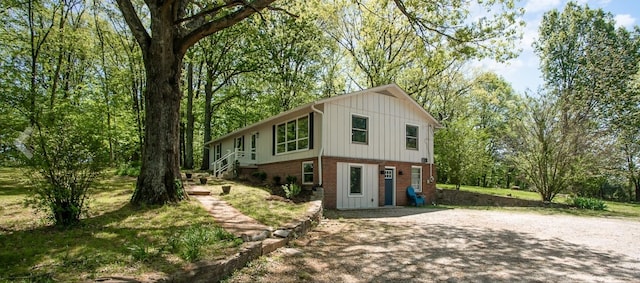 view of front of home featuring brick siding and driveway