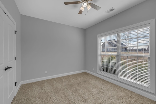 unfurnished room featuring visible vents, ceiling fan, baseboards, and carpet floors