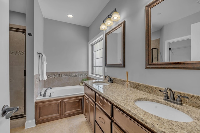 bathroom featuring a sink, a garden tub, a shower stall, and tile patterned flooring