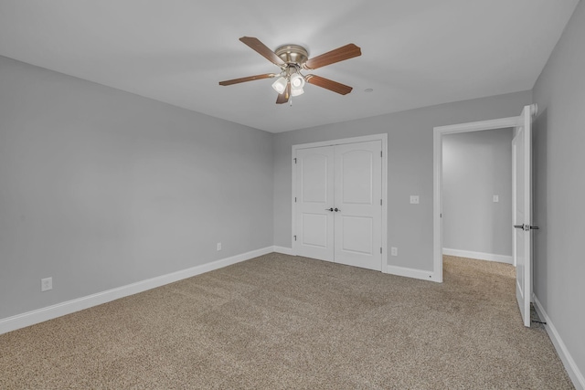 unfurnished bedroom featuring a closet, baseboards, carpet, and a ceiling fan