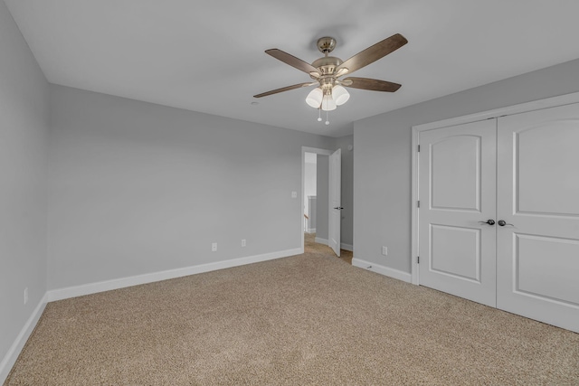 unfurnished bedroom with a closet, ceiling fan, baseboards, and carpet