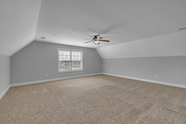 additional living space featuring carpet, lofted ceiling, baseboards, and visible vents