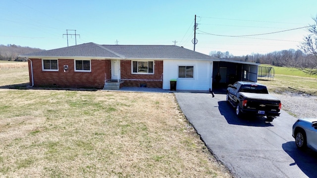 ranch-style house featuring a carport, brick siding, aphalt driveway, and crawl space