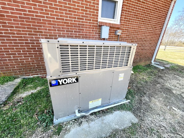 exterior details with central air condition unit and brick siding