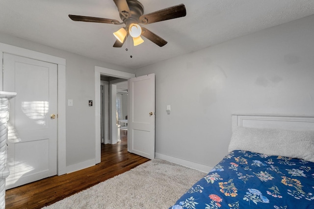 bedroom featuring ceiling fan, baseboards, and wood finished floors