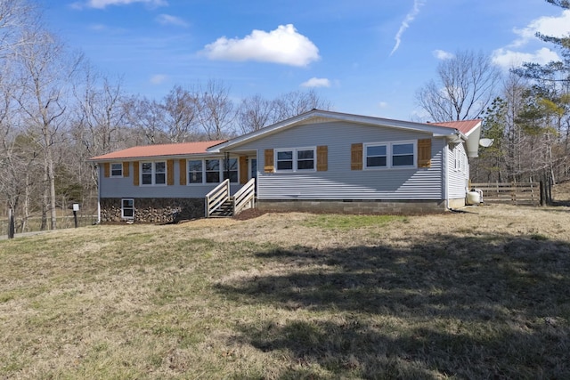 view of front of property with metal roof, a front yard, and fence