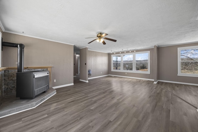 unfurnished living room featuring ornamental molding, a textured ceiling, a wood stove, and dark wood-style flooring