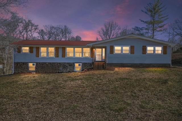 view of front of house with entry steps, metal roof, and a front yard