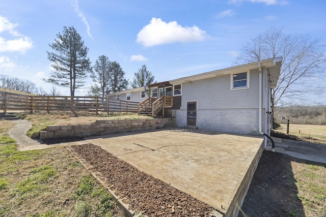 rear view of property with a patio and fence