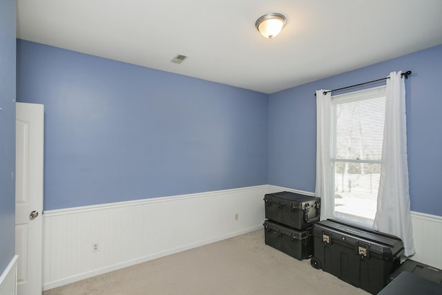 misc room with visible vents, carpet floors, and wainscoting