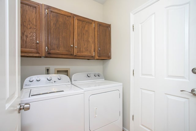 laundry area with washing machine and clothes dryer and cabinet space