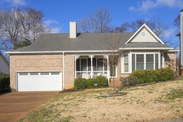 view of front of property with concrete driveway, brick siding, covered porch, and a chimney