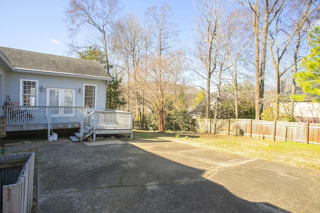 view of yard featuring french doors, fence private yard, and a deck