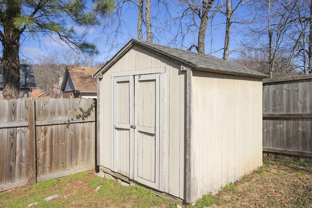 view of shed featuring fence