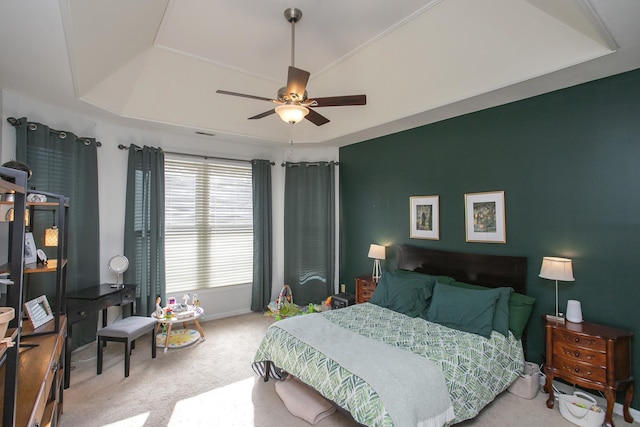 bedroom featuring a tray ceiling, baseboards, a ceiling fan, and carpet flooring