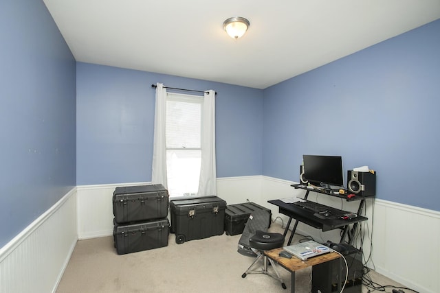 office space featuring a wainscoted wall and carpet