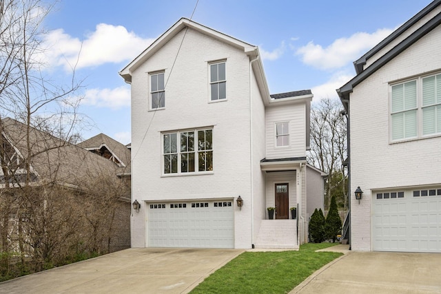 view of front of house with a garage, brick siding, and driveway