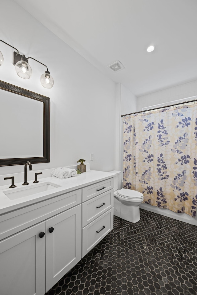 bathroom with a shower with shower curtain, visible vents, toilet, and vanity