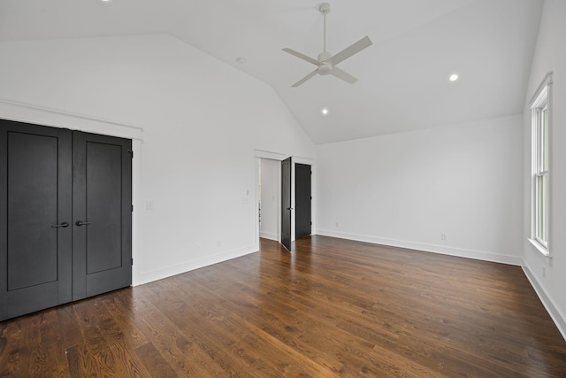 unfurnished bedroom with a ceiling fan, baseboards, dark wood-style flooring, and high vaulted ceiling