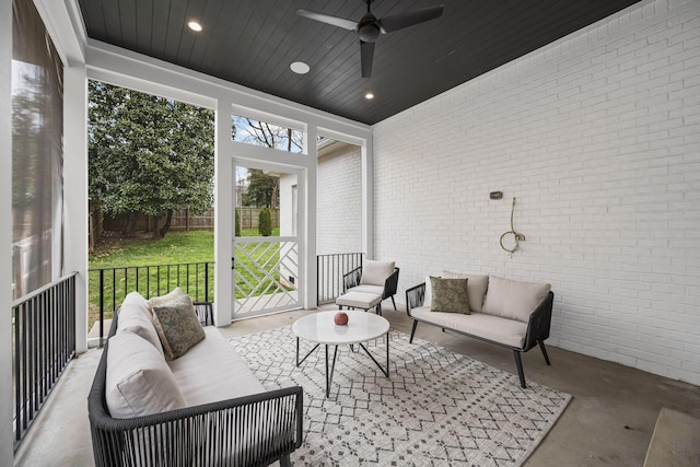 sunroom / solarium with wood ceiling and a ceiling fan