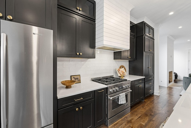 kitchen featuring stainless steel appliances, dark wood-type flooring, tasteful backsplash, and light countertops