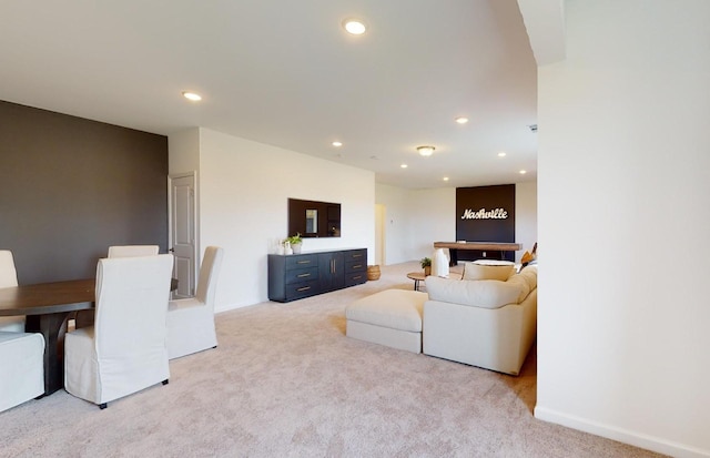 living area featuring recessed lighting and carpet