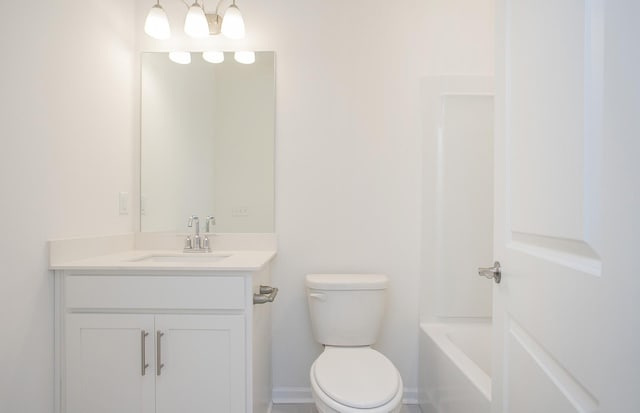 bathroom with baseboards, toilet, and vanity