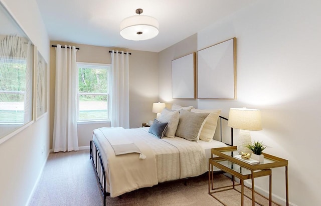 bedroom featuring carpet flooring and baseboards