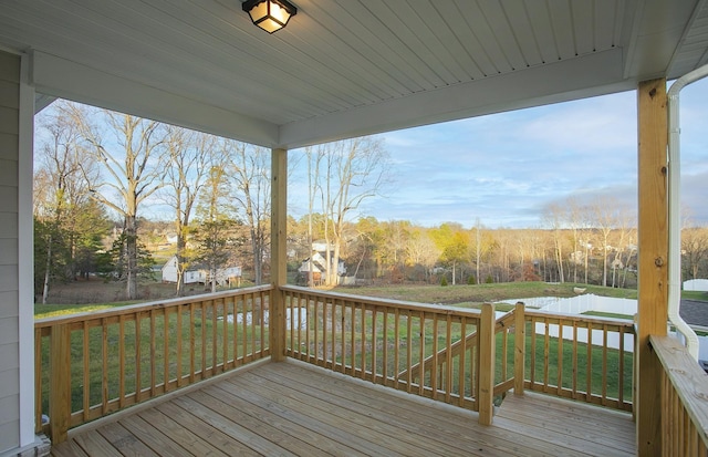 wooden deck featuring a lawn