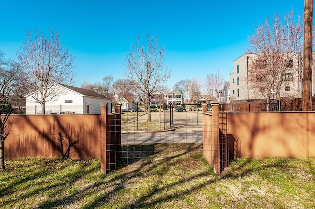 view of yard featuring a gate, a residential view, and fence