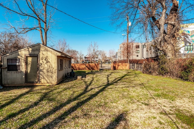 view of yard with a storage unit, an outdoor structure, and fence