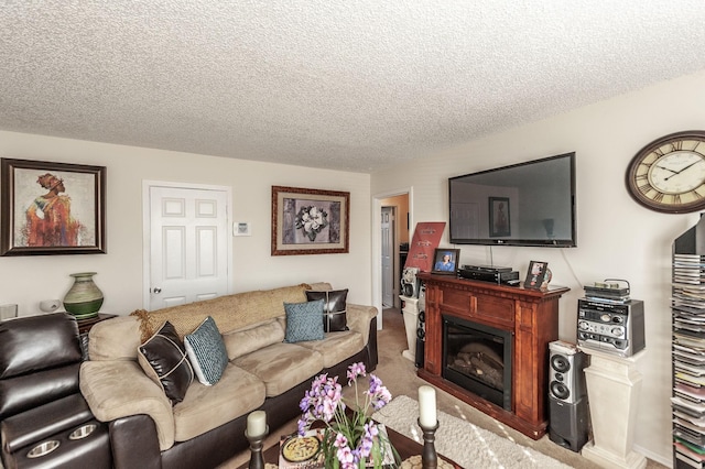 living area with a glass covered fireplace, carpet flooring, and a textured ceiling