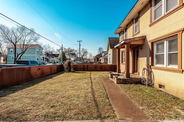 view of yard with a residential view and fence