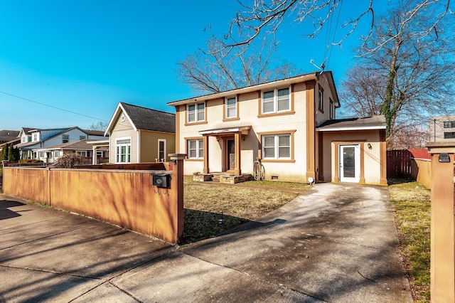 view of front of property featuring crawl space, a residential view, a fenced front yard, and stucco siding